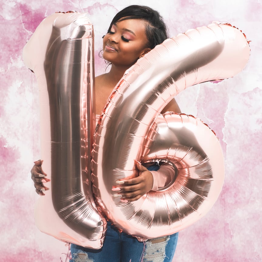 Woman Holding Number 16 Balloons